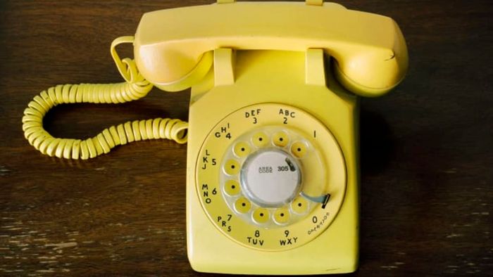 A yellow rotary phone.