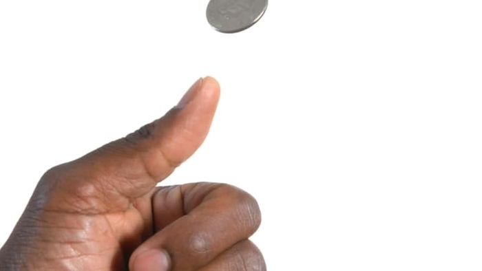 Thumb flipping a coin.