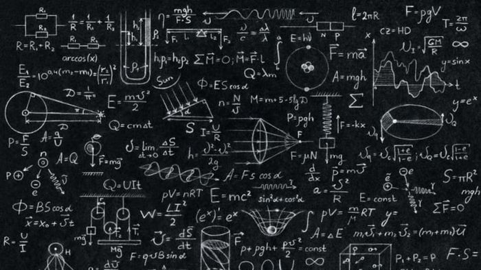 A blackboard covered with math and science equations.