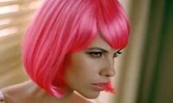 A woman with bright pink chin-length hair.