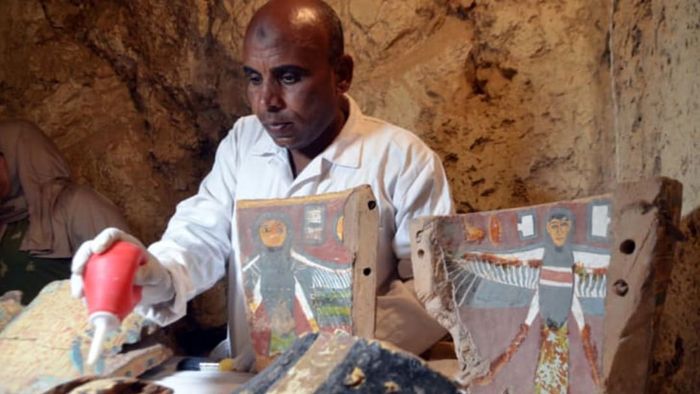 On December 9, 2017, an Egyptian archaeological technician works to restore artifacts discovered in the newly unearthed 'Kampp 161' tomb at the Draa Abul Naga necropolis, located on the west bank of the Nile in Luxor, around 400 miles south of Cairo.