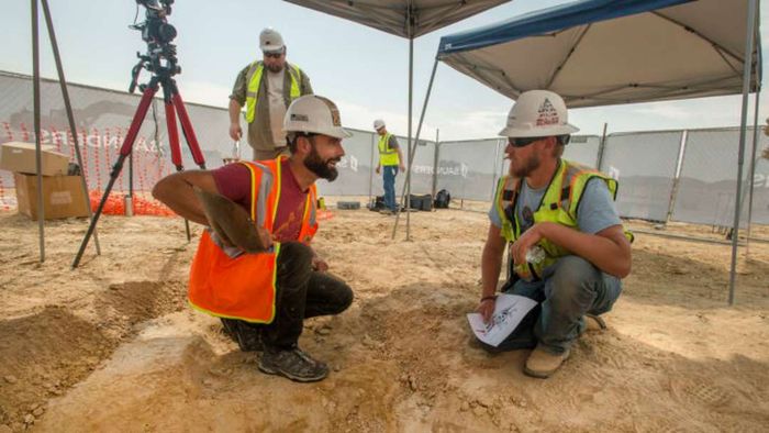 Joe Sertich, the dinosaur curator at the Denver Museum of Nature & Science, engages with a construction worker while overseeing the excavation of the newly discovered Triceratops skeleton in Thornton, Colorado.