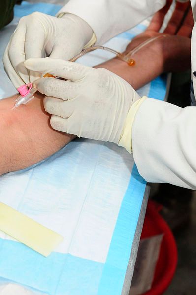 Image: A young Afghan female student is seen administering an intravenous injection (4509653817).jpg