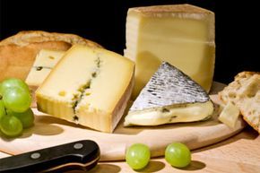 slices of cheese paired with fresh grapes