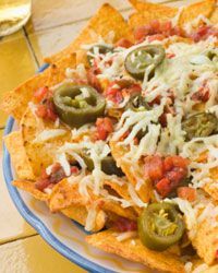 plate of nachos topped with cheese and other ingredients