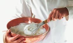 chef using a hand whisk