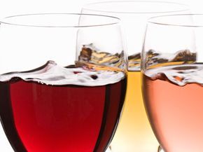 Glasses filled with red, white, and rosé wines.