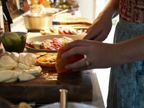 A woman chopping tomatoes