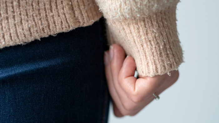 A close-up view of the cuff on a sweater showing pilling