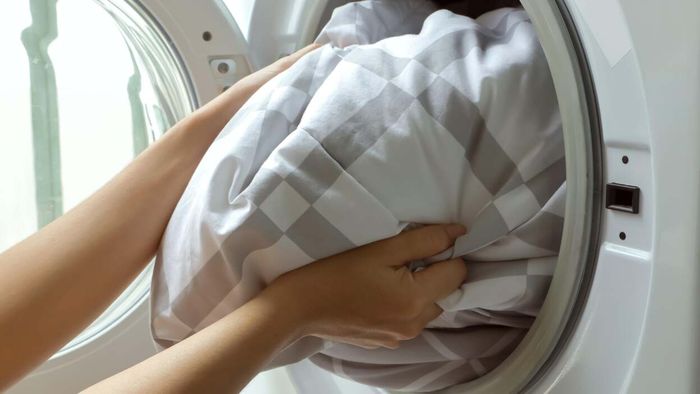 Putting a blanket in the washing machine