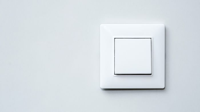 gray wall with a light switch