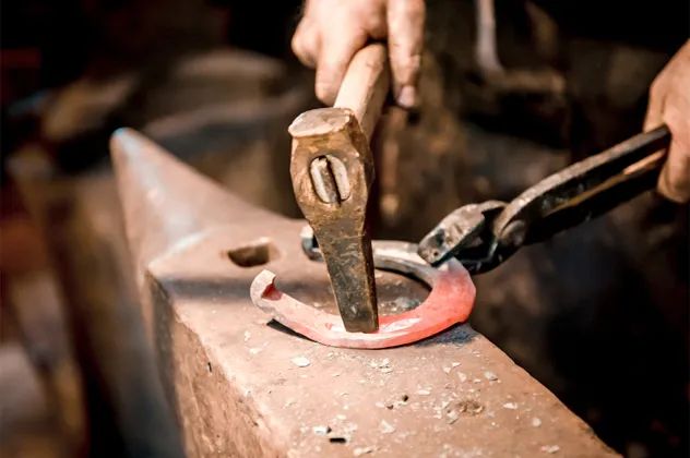 Blacksmiths craft horseshoes