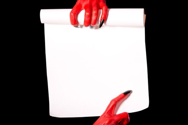 Red devil hands holding paper scroll
