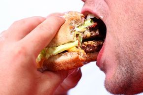 enjoying a juicy burger