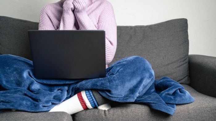 Woman relaxing on a couch with a laptop