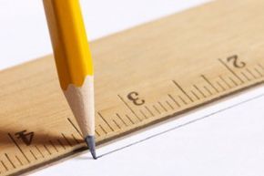 A wooden pencil glides across paper, creating precise lines...