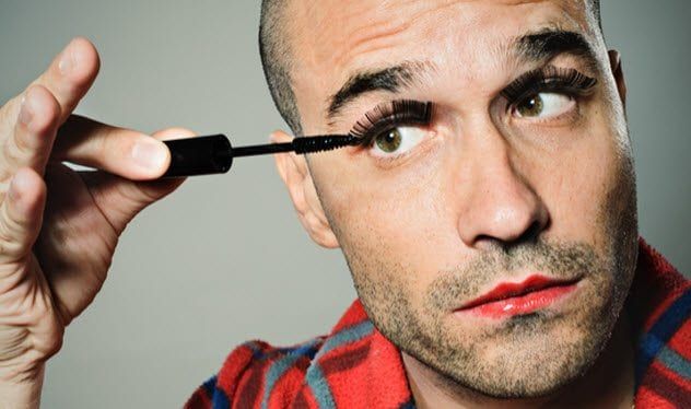 9a-man-applying-mascara-108219338