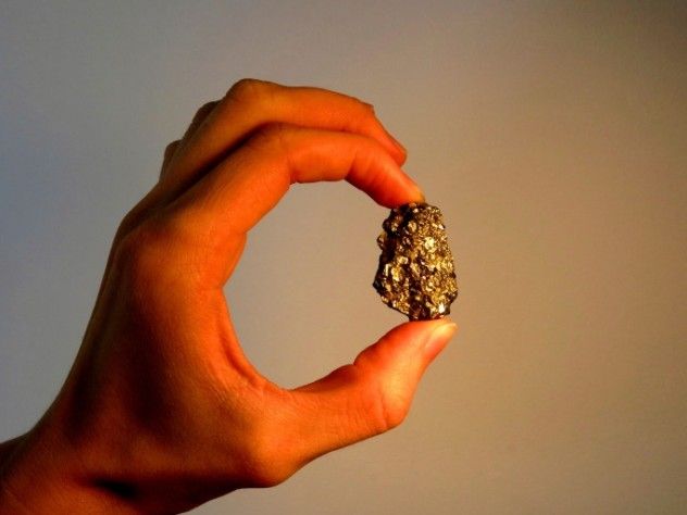 Hand Holding a Gold Nugget