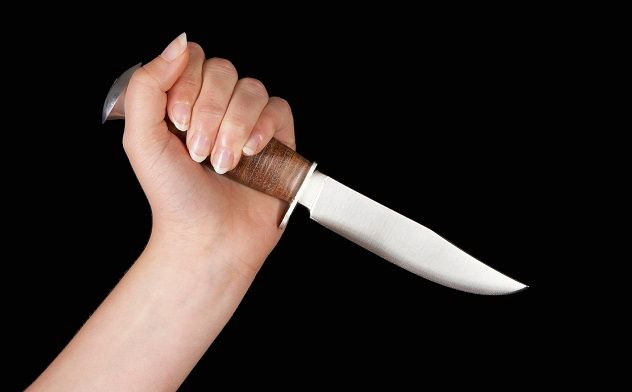 Hand with a dagger making a stabbing gesture