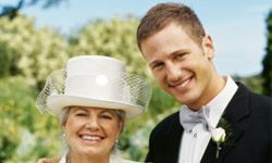 a son standing beside his mother