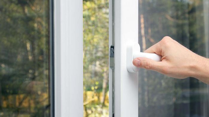 a hand opening a window