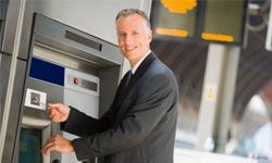 man using an ATM machine