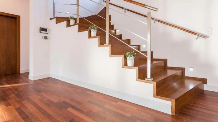 A staircase in a home where the area beneath is sealed with drywall