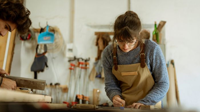 a woman crafting a DIY project at her workbench