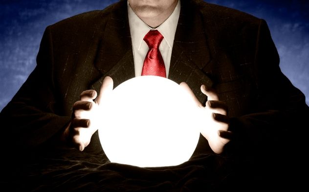Businessman Consulting Glowing Crystal Ball
