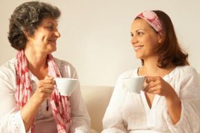 A mother and daughter sharing a heartfelt conversation over coffee