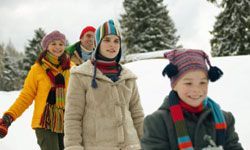 family trekking through snowy terrain
