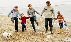 family strolling along the beach