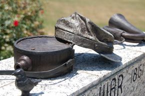 The donated items were bronzed for permanent outdoor display, mounted on pedestals that feature the names of community members who served in various wars.