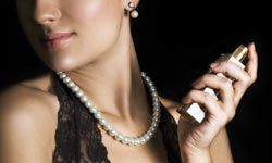 a woman applying perfume