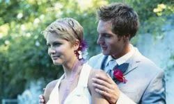 A bride and groom standing outdoors