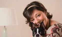 A woman wearing a headband with her dog