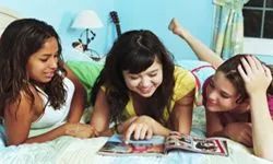 Young women browsing a fashion magazine.
