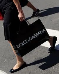 A woman carrying a shopping bag.