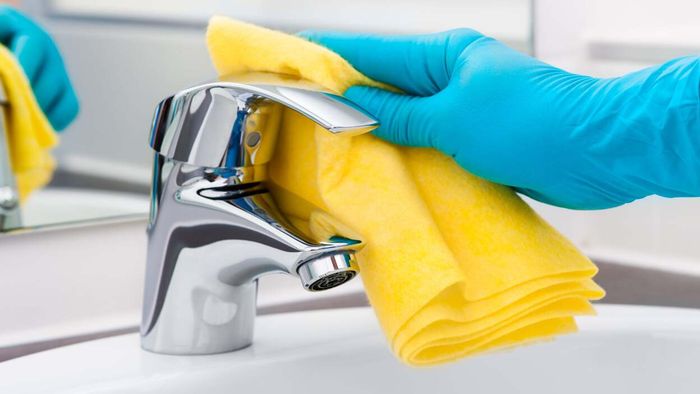 Clean bathroom fixtures like toilets, faucets, and tubs