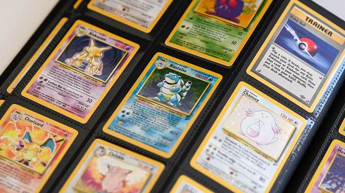 A collection of Pokémon cards neatly organized in a 3 x 3 grid within a binder