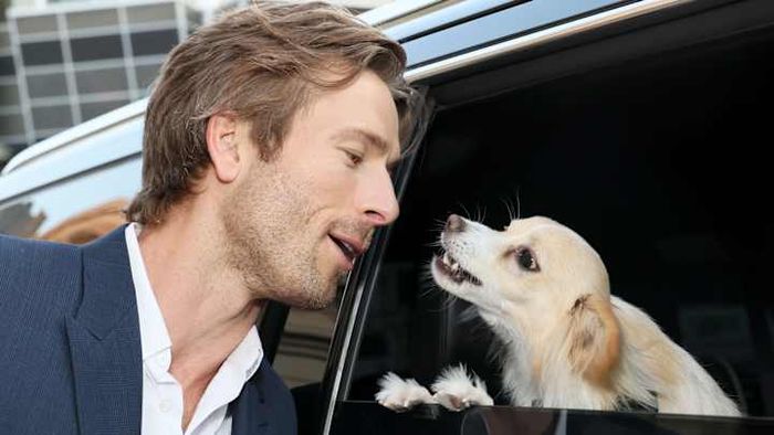 Glen Powell (left) with his dog Brisket in 2024.