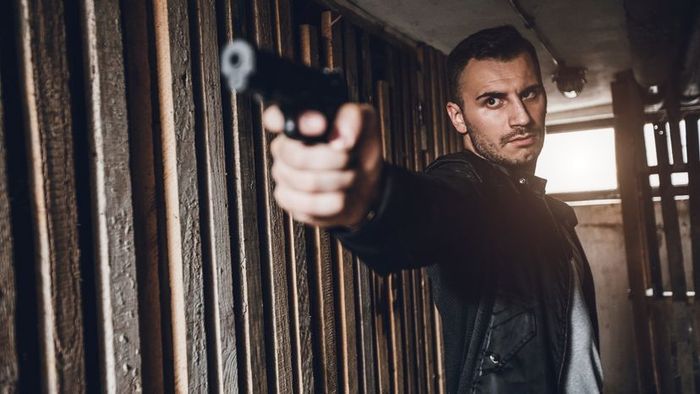 A man gripping a firearm