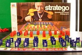The Stratego game set, featuring the board and pieces arranged for play.