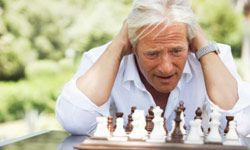 A person deeply focused on a chess game