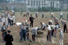 Inmates labor in the fields in a scene from