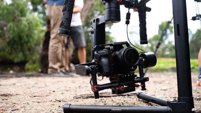 A gimbal-mounted camera positioned on the ground.
