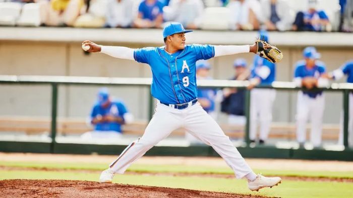 A pitcher poised to hurl a baseball from the mound