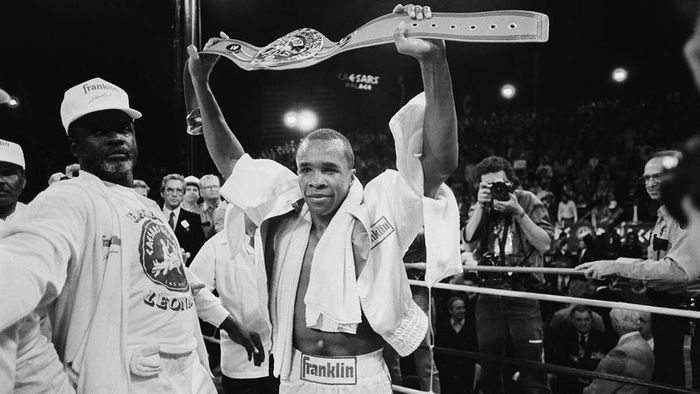 Sugar Ray Leonard proudly displaying his championship belt