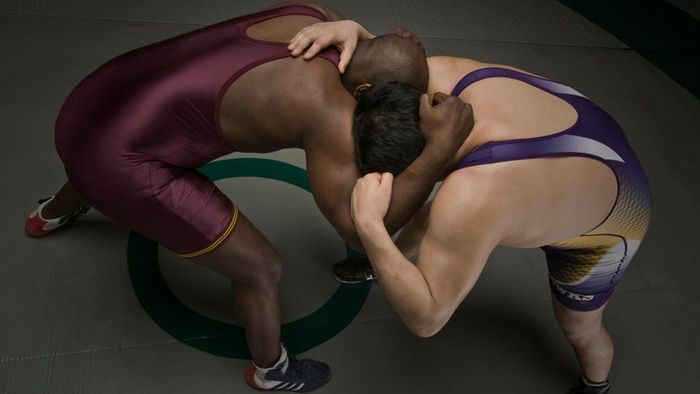 Two athletes engaged in a wrestling match.