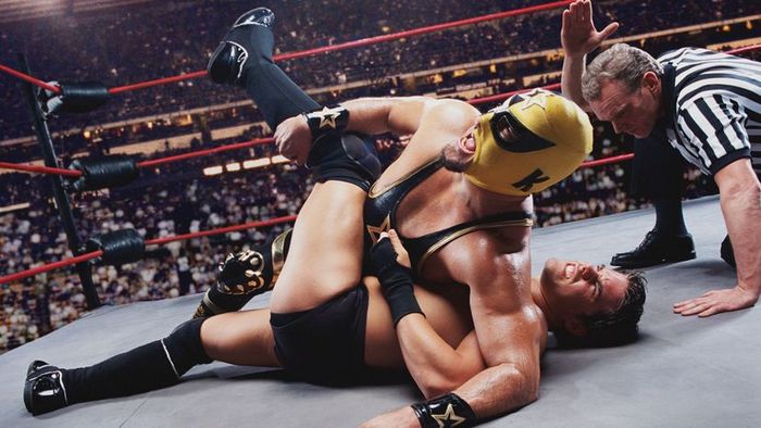 Two wrestlers engaged in a ground battle.